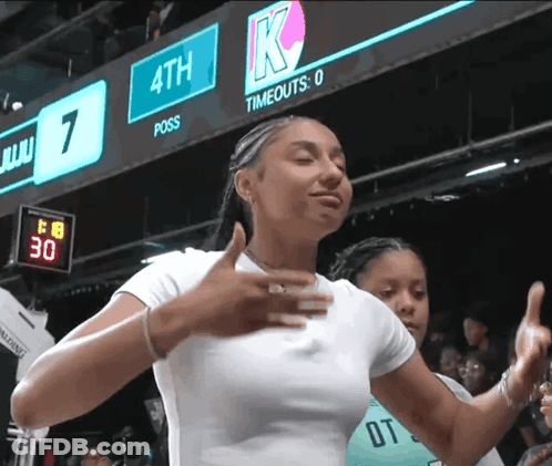 Woman Giving Thumbs Up In Front Of 4Th Scoreboard GIF