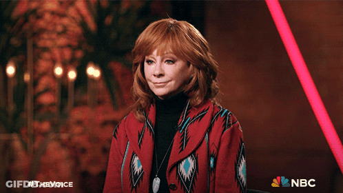 Woman Giving Thumbs Up In Front Of NBC Sign GIF
