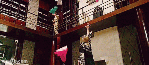 Woman Hanging Upside Down From Balcony GIF