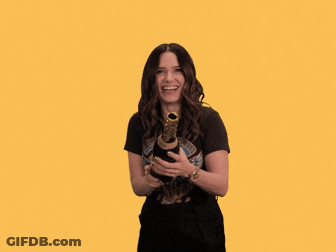 Woman Happily Popping Falling Confetti GIF