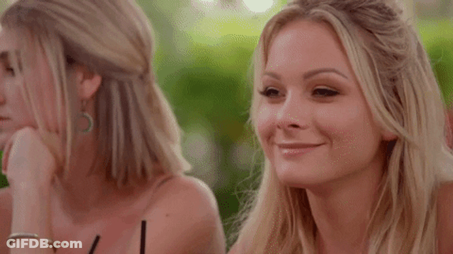 Woman Head Down With Smile On Her Face GIF