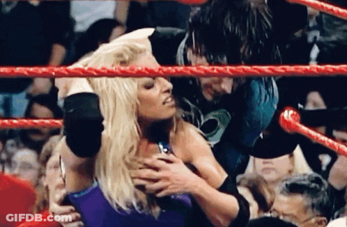 Woman Held By Man In Wrestling Ring GIF