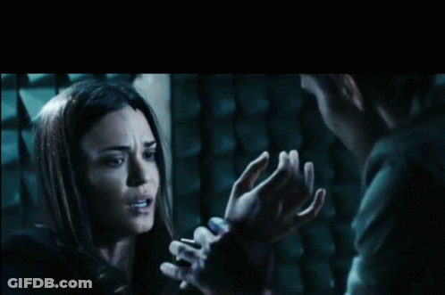 Woman Held By Man's Hands In Dark Room GIF