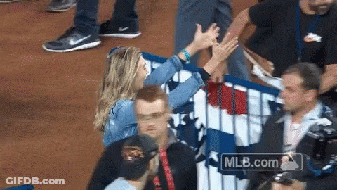 Woman High Fives Man Behind Fence With MLB.com GIF