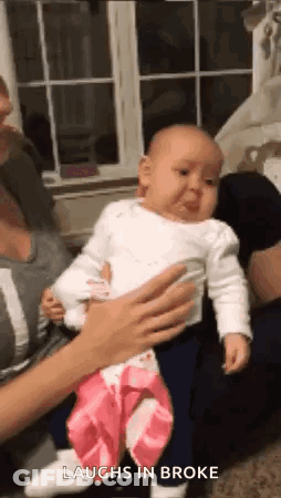Woman Holding Baby Crying And Laughing GIF