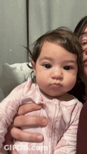 Woman Holding Baby In Pink Floral Outfit GIF