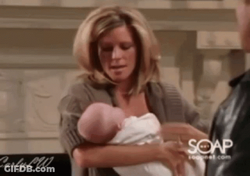 Woman Holding Baby Next To Man GIF