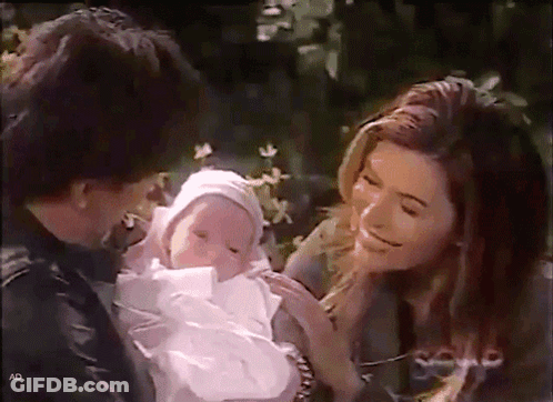 Woman Holding Baby With Letters AD GIF