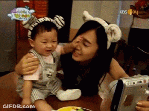 Woman Holding Baby With Zebra Headband GIF