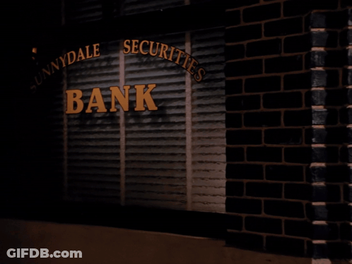 Woman Holding Bag In Front Of Innydale Securities Bank GIF