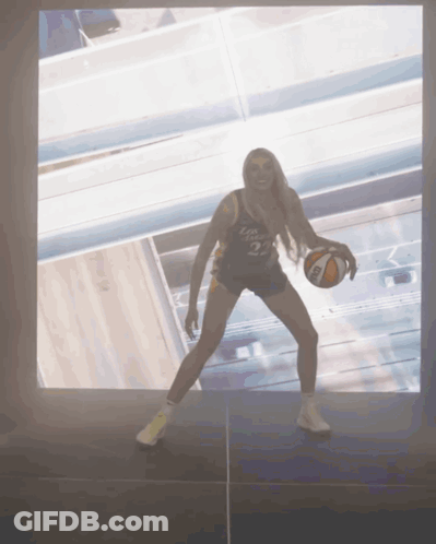 Woman Holding Basketball With Number 3 On Shirt GIF
