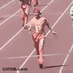 Woman Holding Baton Crossing Finish Line On Track GIF