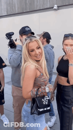 Woman Holding Black Bag Saying Vogue GIF