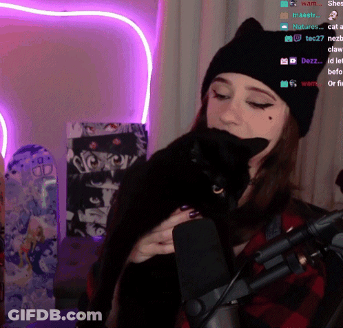 Woman Holding Black Cat Near Microphone Purple Heart GIF