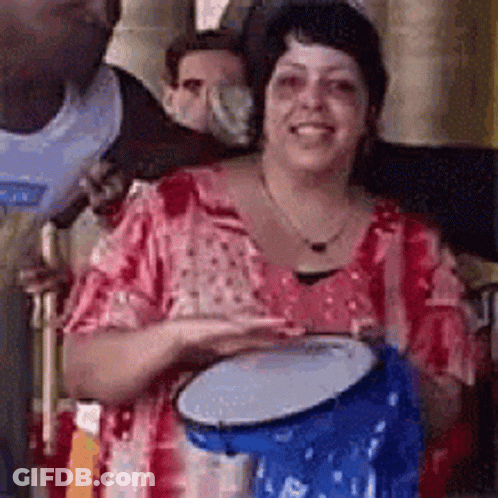 Woman Holding Blue Drum Smiling GIF
