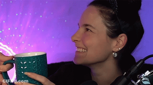 Woman Holding Blue Mug In Front Of Microphone GIF
