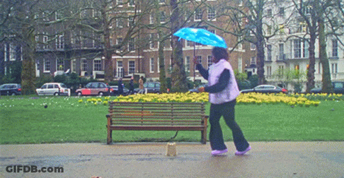 Woman Holding Blue Umbrella In Rain GIF