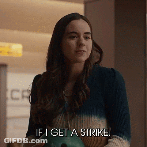 Woman Holding Bowling Ball Talking About Strike GIF