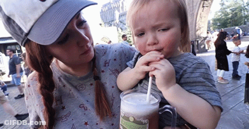 Woman Holding Boy Drinking From Mug GIF