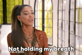 Woman Holding Breath With Ponytail And Necklace GIF