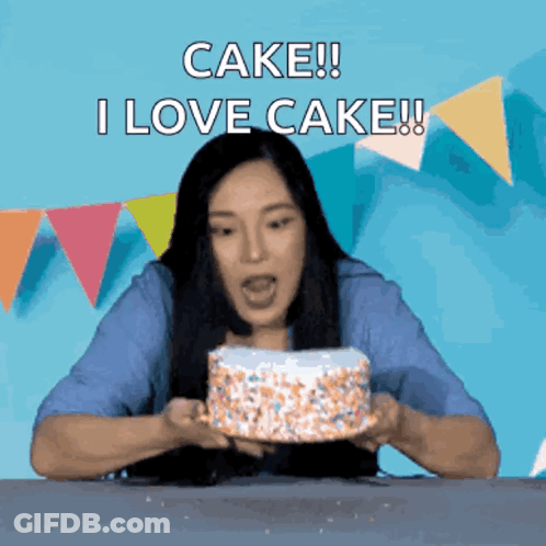 Woman Holding Cake That Says I Love Cake GIF