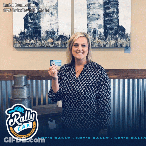 Woman Holding Card In Front Of Rally C.A.P. Sign GIF