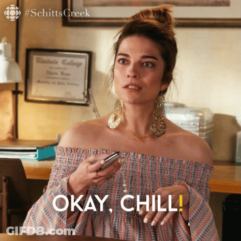 Woman Holding Cell Phone Says Okay Chill GIF