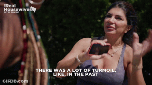 Woman Holding Cell Phone Says There Was A Lot Of Turmoil In The Past GIF