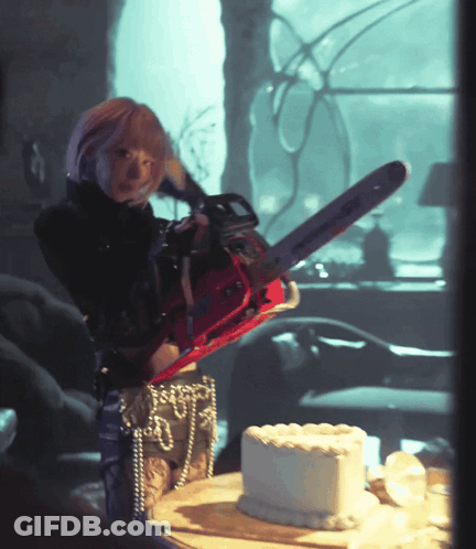 Woman Holding Chainsaw Over Cake GIF