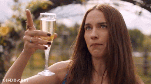 Woman Holding Champagne And Pointing Up GIF