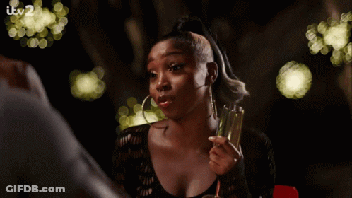 Woman Holding Champagne Glass With Itv2 Sign GIF