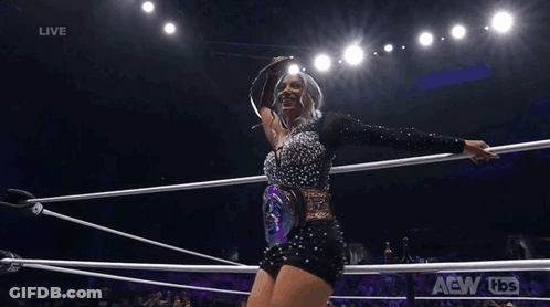 Woman Holding Championship Belt In Wrestling Ring GIF