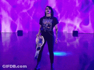 Woman Holding Championship Belt On Stage GIF