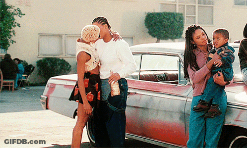 Woman Holding Child Next To Kissing Couple In Front Of Car GIF