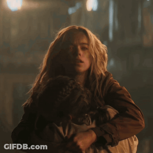 Woman Holding Child With Red Glowing Eyes GIF