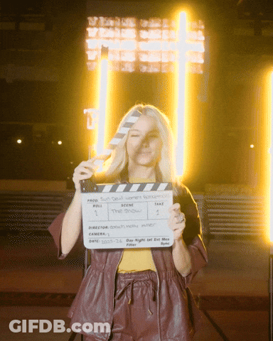 Woman Holding Clapper Board Saying The Show GIF