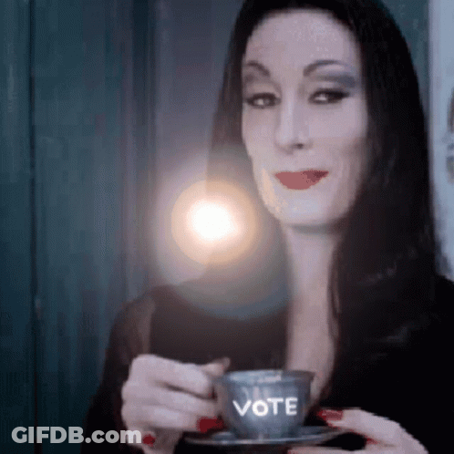 Woman Holding Coffee Cup Saying Vote GIF