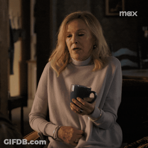 Woman Holding Coffee Cup With Max Logo GIF