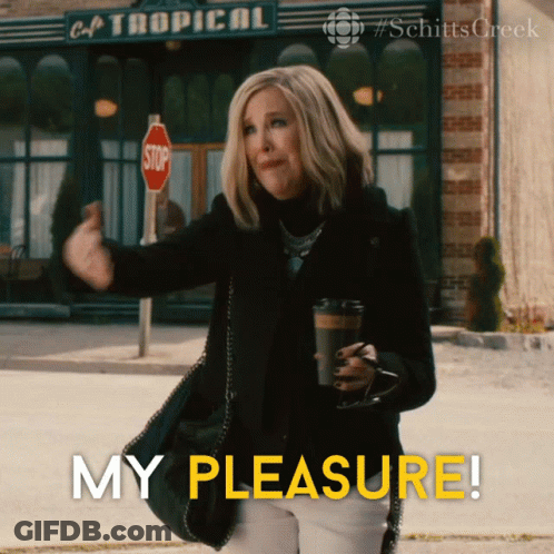 Woman Holding Coffee In Front Of Cafe Tropical GIF