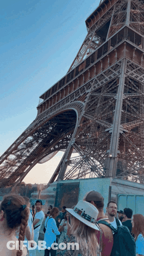 Woman Holding Coffee In Front Of Jewel Symphony Sign GIF