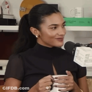 Woman Holding Coffee Smiling Into Microphone GIF