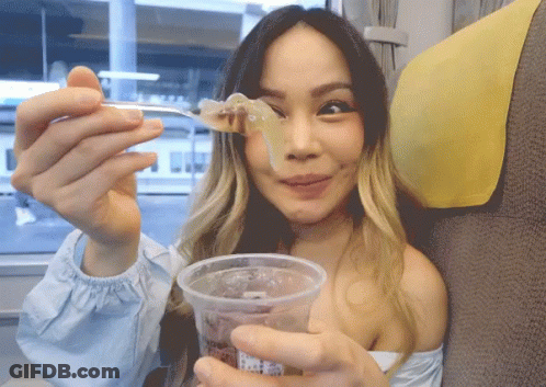 Woman Holding Cup And Spoon With Food GIF