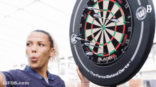 Woman Holding Dart Board Saying Force Behind Darts GIF