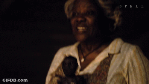 Woman Holding Doll With Spell GIF