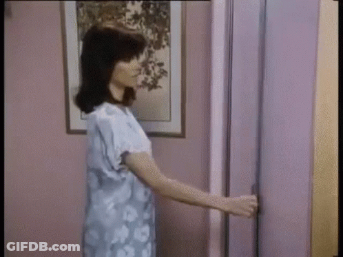 Woman Holding Door Open GIF