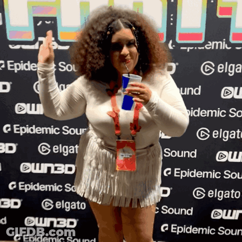 Woman Holding Drink In Front Of Epidemic Sour Wall GIF