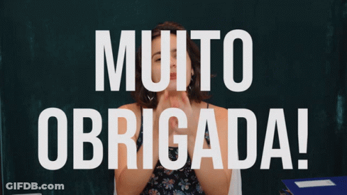 Woman Holding Fist In Front Of Muito Obrigada Sign GIF