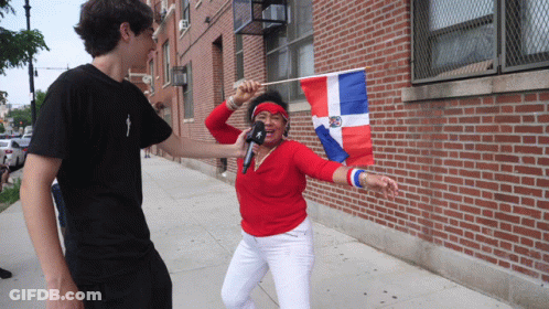 Woman Holding Flag And Microphone Interviewed By Man GIF