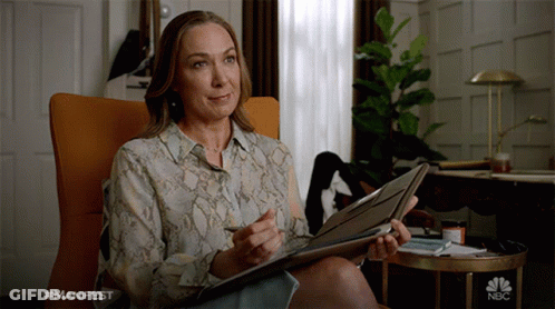 Woman Holding Folder With NBC Logo GIF