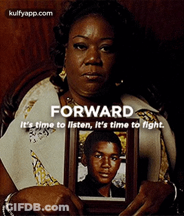 Woman Holding Framed Picture Of Young Boy GIF